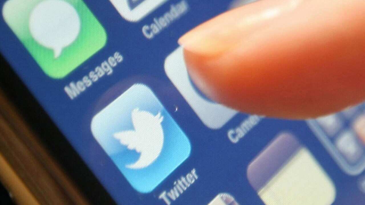 The Twitter logo on a smartphone