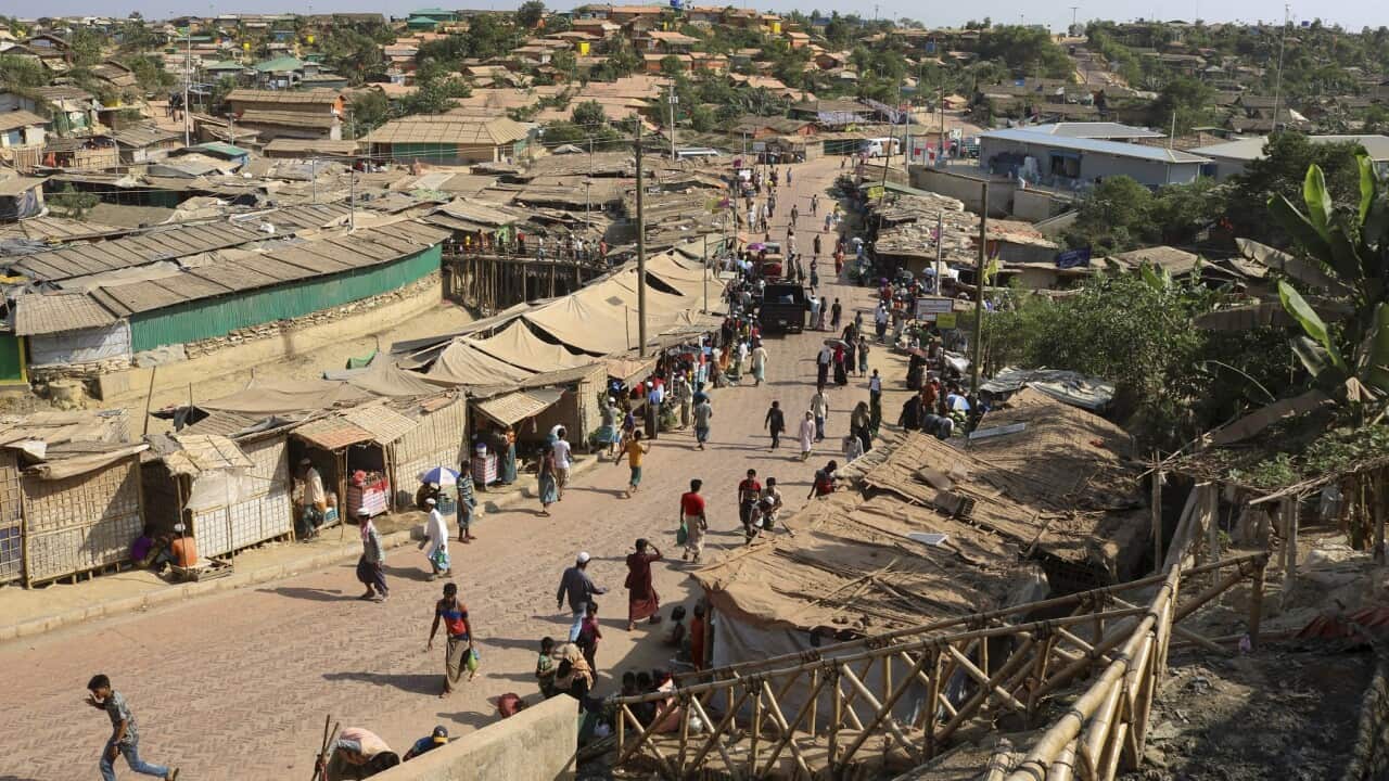 Rohingya refugees walk through one of the arterial roads at the Kutupalong refugee camp in Cox's Bazar, Bangladesh (AAP).