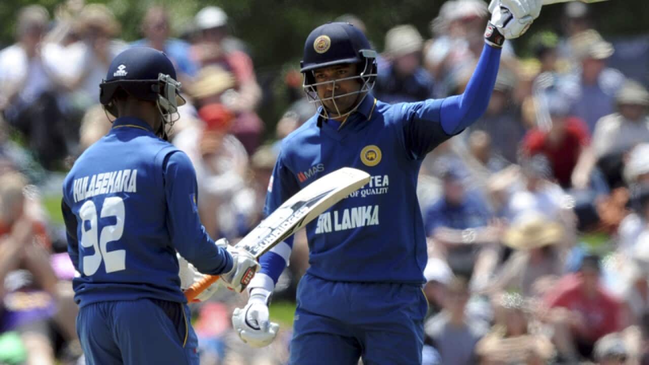 Sri Lanka’s Milinda Siriwardana (R) salutes his 50 runs