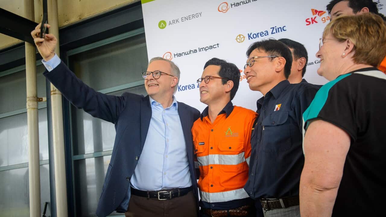 Prime Minister Anthony Albanese takes a selfie with workers during a tour of the Ark Energy and Sun Metals sites in Townsville, Queensland.