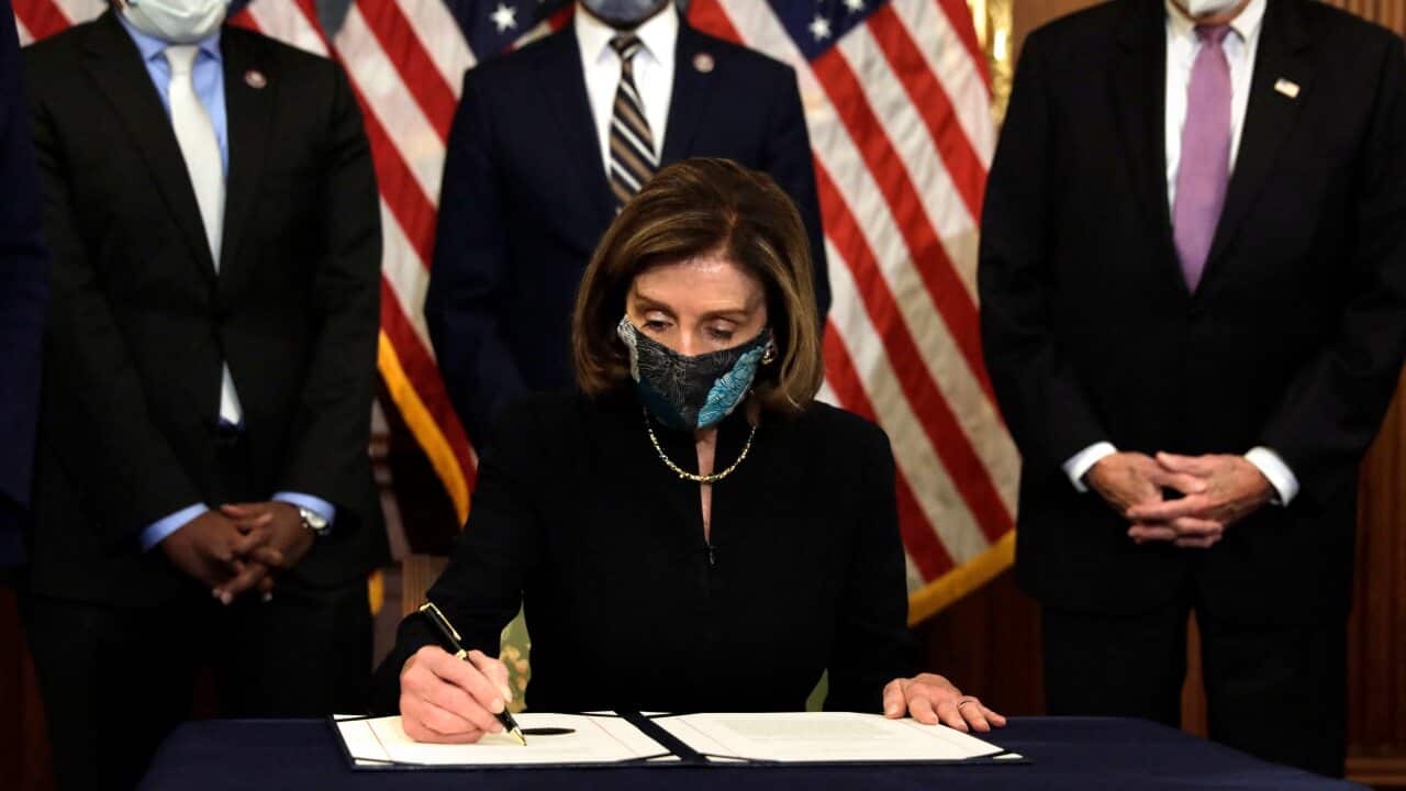 Nancy Pelosi signs the article of the impeachment against President Donald Trump