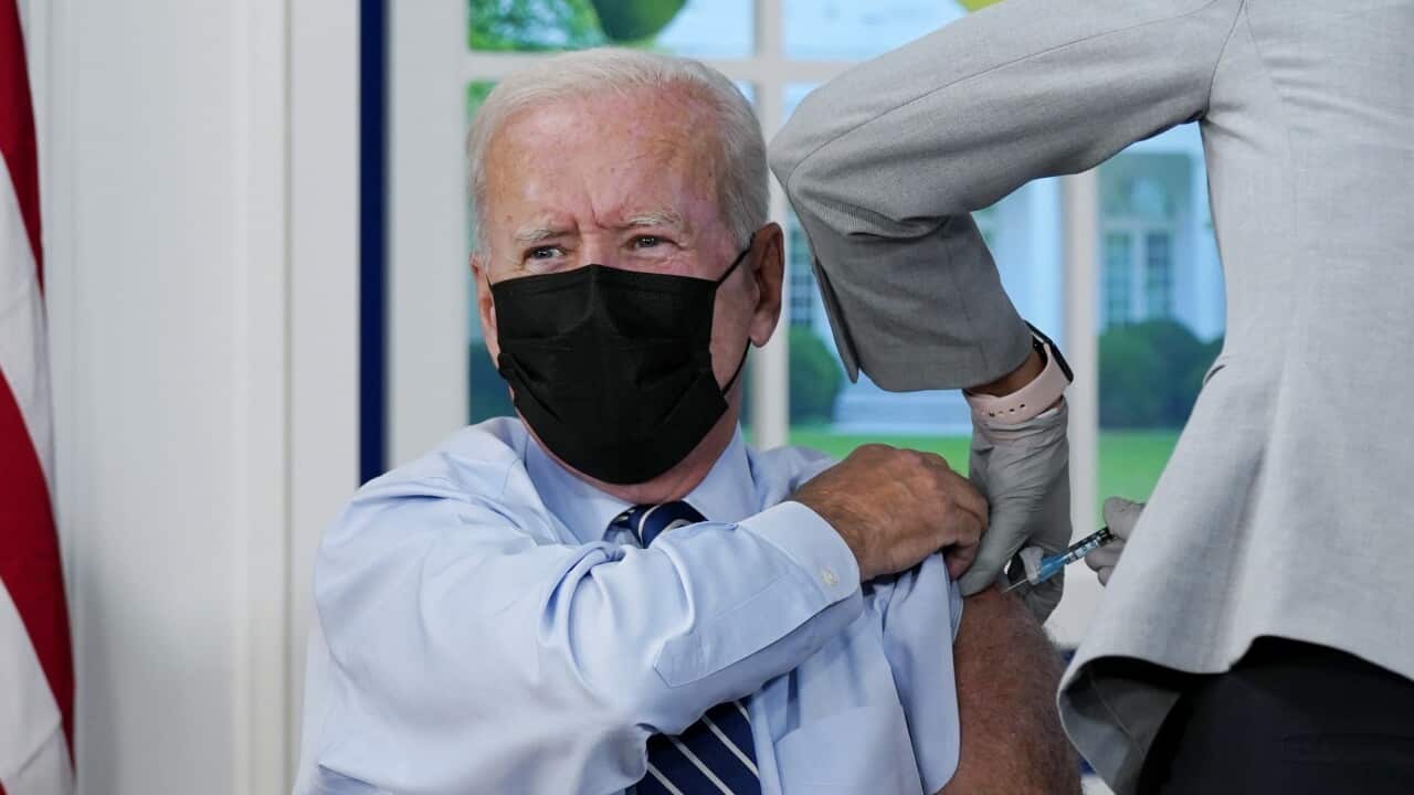Joe Biden receives a COVID-19 booster shot during an event in the South Court Auditorium at the White House