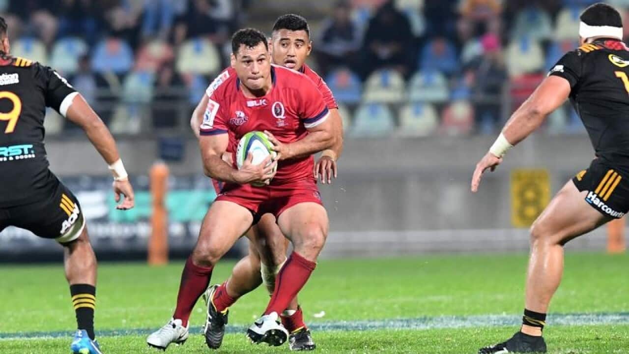 George Smith of the Reds attempts to split the Chiefs defence.