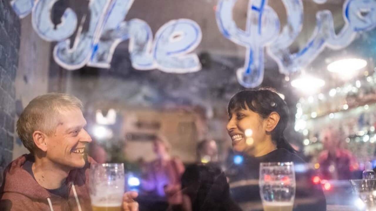 A couple enjoy drinks at a Sydney venue