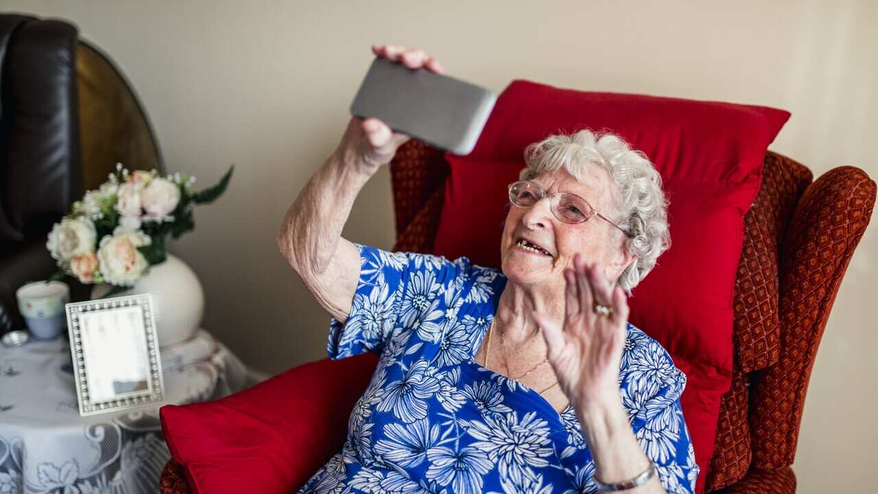 Elderly Woman Using A Mobile Telephone