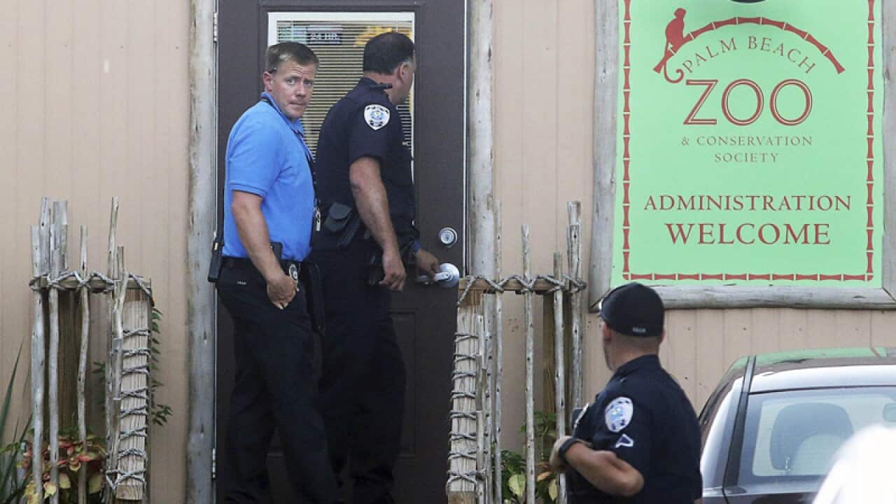 Police officers enter the Palm Beach Zoo