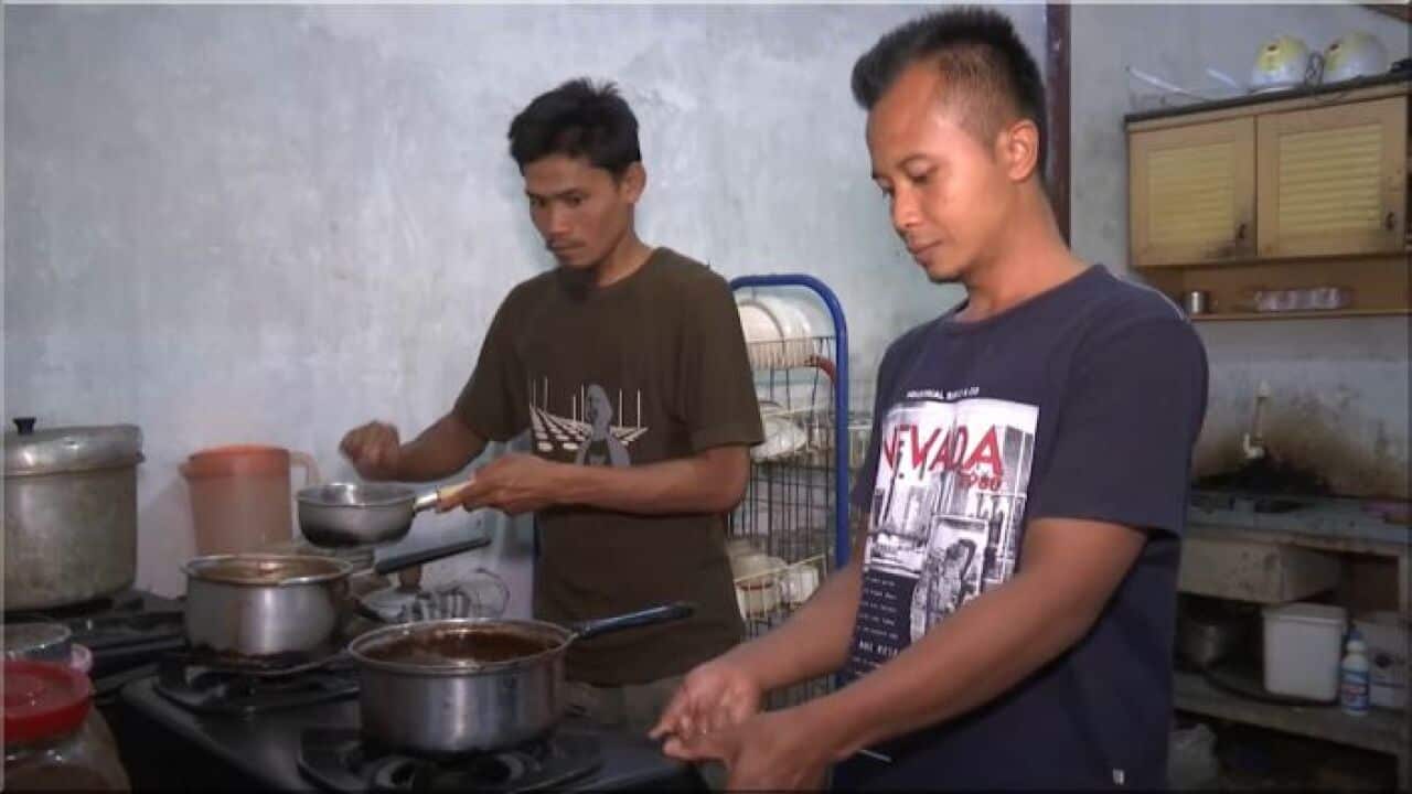 Ahmad Azhar and Salman Al Faluty making coffee in the cafe