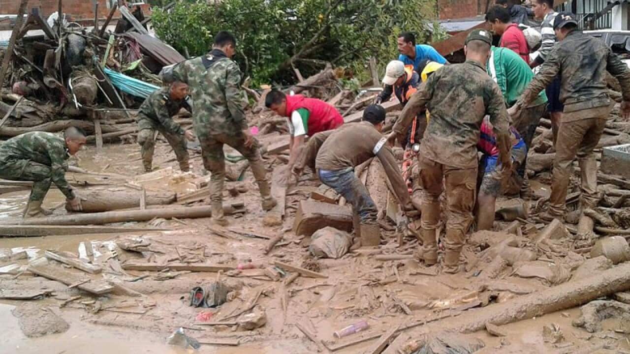 Soldiers work to rescue victims of a landslide in Mocoa, Colombia