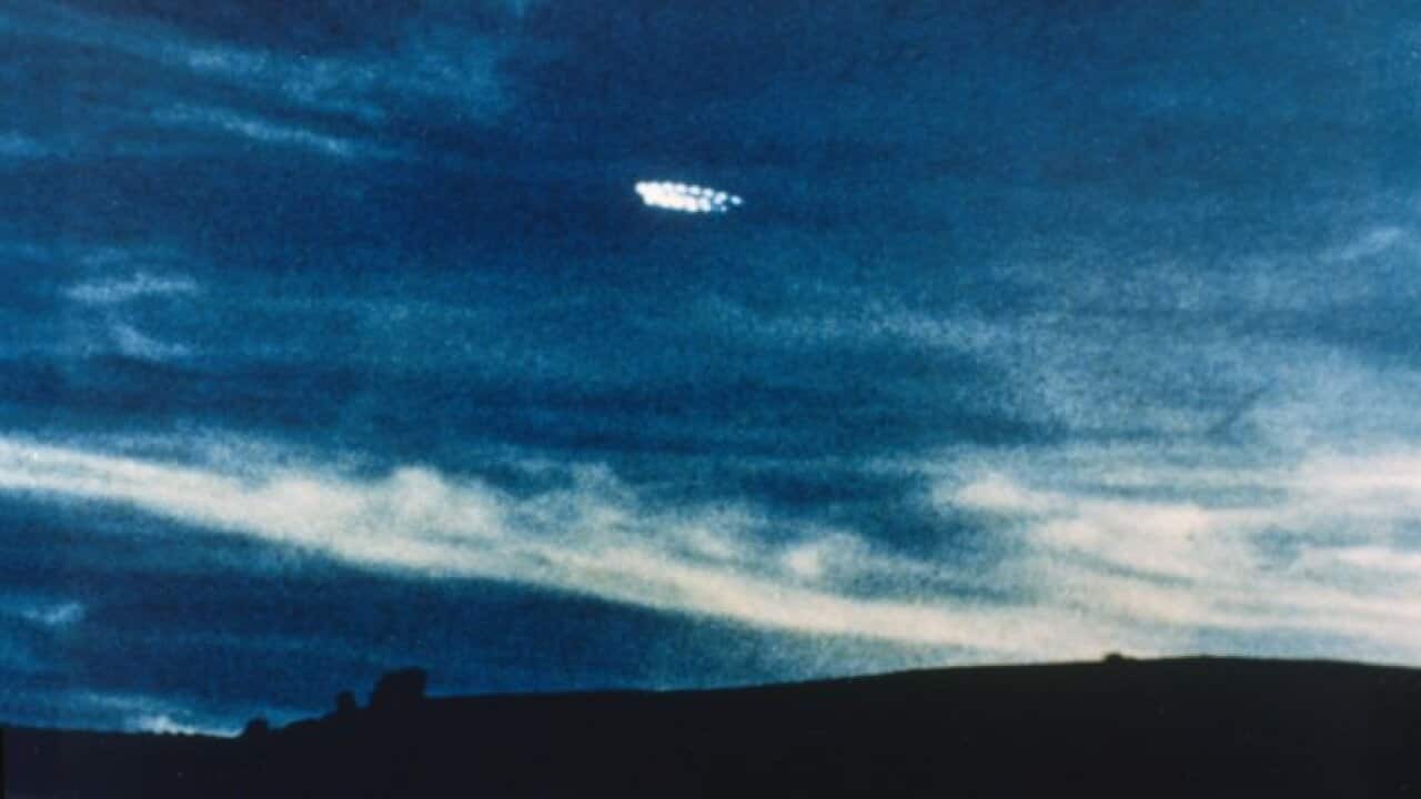 UFO comprising a ring of lights, photographed in the evening sky by Fred and Phyll Dickeson of Timaru, New Zealand Date: 27 October 1979