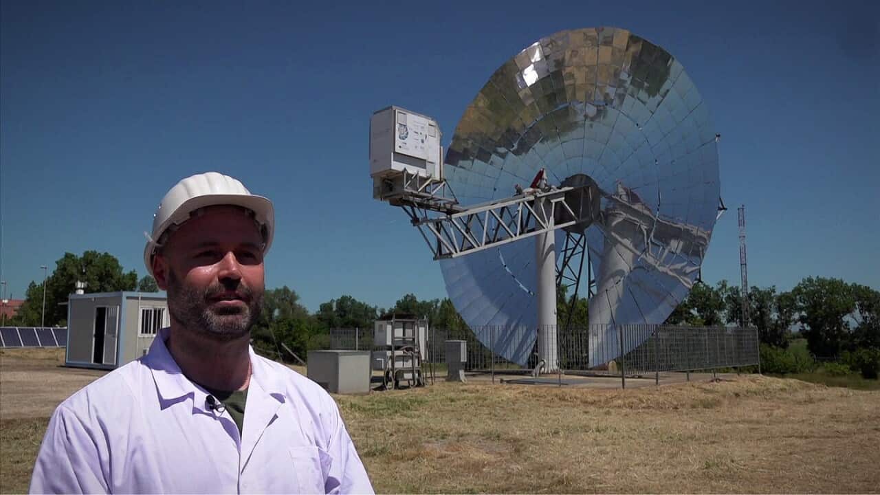 Solar power researcher Luca Turchetti with the massive solar generator (AP).jpg
