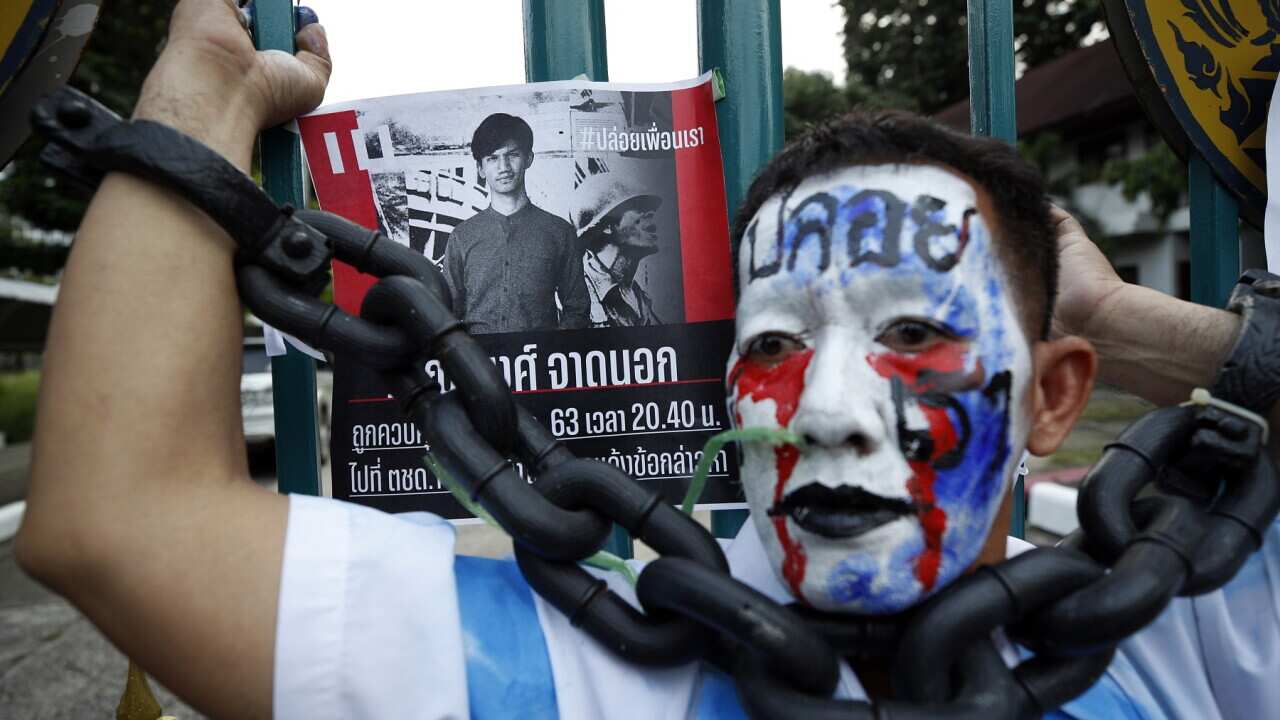 A pro-democracy activist attends a rally urging the release of protests leaders Panupong Jadnok, Panusaya Sithijirawattanakul and Parit Chiwarak.