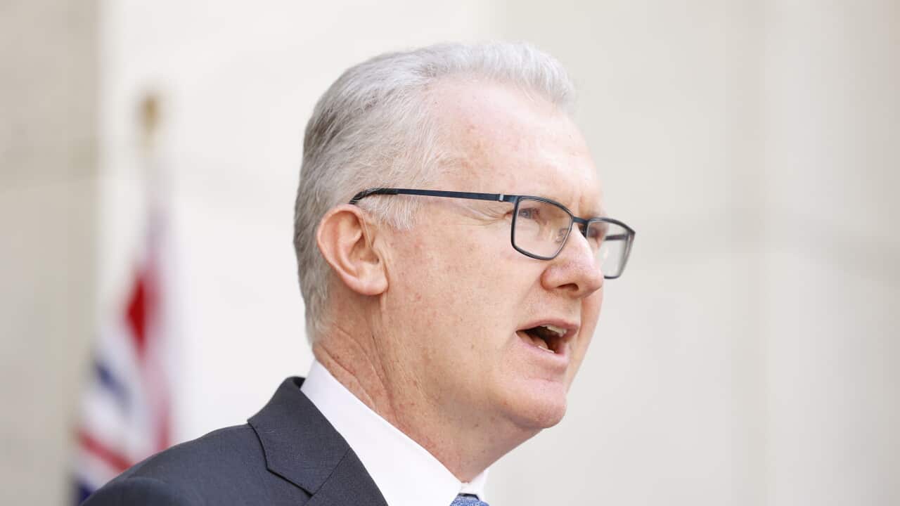 A man in a suit speaking.