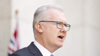 A man in a suit speaking.