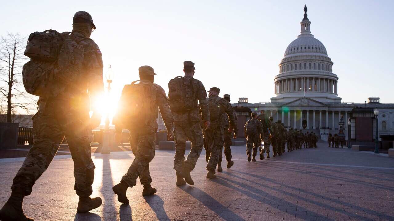 Members of the US National Guard gather on the grounds of the East Front of the US Capitol in Washington, DC, USA, 12 January 2021. At least ten thousand troops of the National Guard will be deployed in Washington by the end of the week.