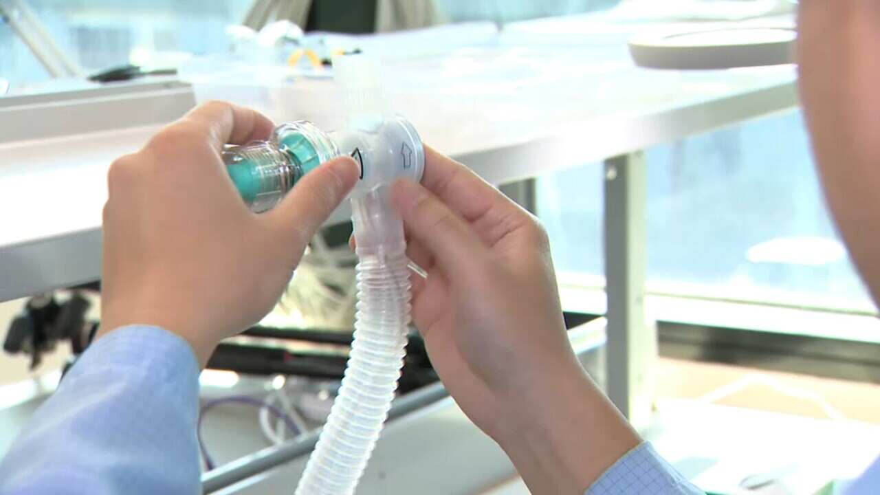 Worker makes a ventilator