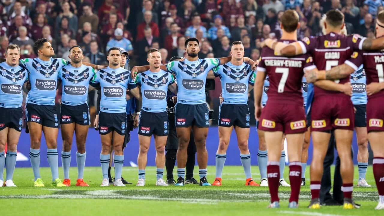 QLD Maroons and NSW Blues players line up for the National Anthem before Game 1 of the 2019 State of Origin series.