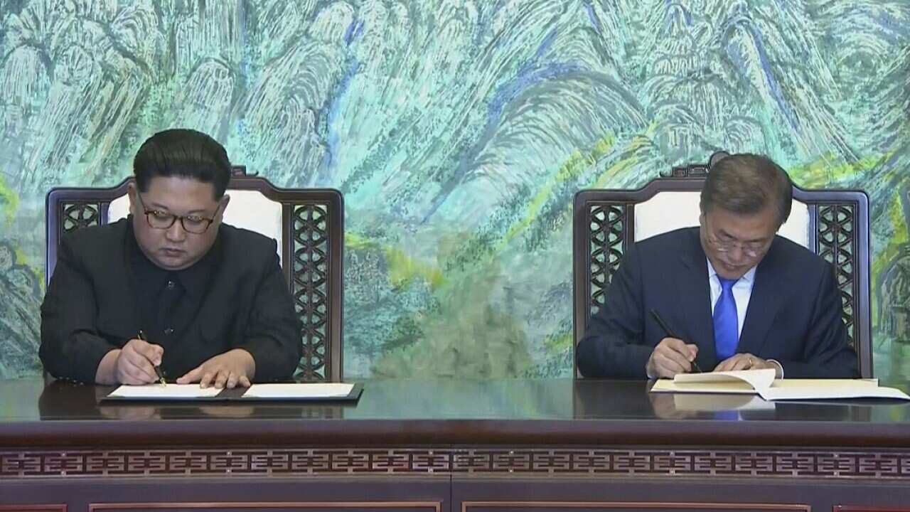 North Korean leader Kim Jong-un and South Korean President Moon Jae-in sign a joint statement at the border village of Panmunjom in the Demilitarised Zone.