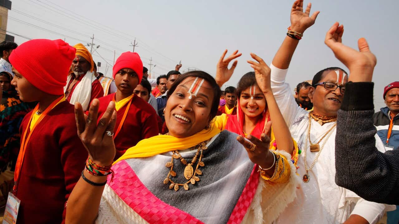 Hindu devotees dance during a religious procession at the Kumbh Festival.