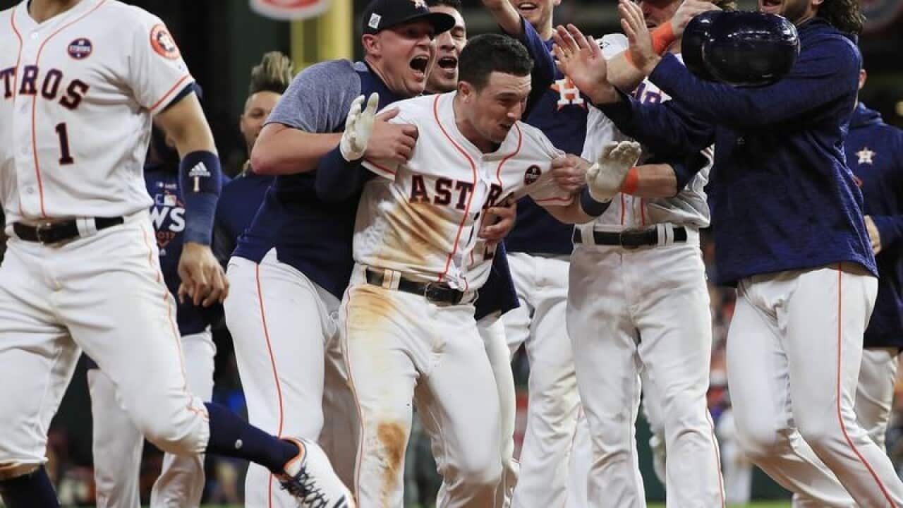 Houston Astros batter Alex Bregman is mobbed by teammates