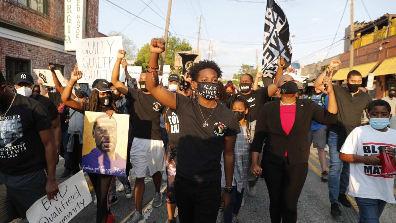 People march after former Minneapolis Police Department Police Officer Derek Chauvin was found guilty on all counts in the death of George Floyd, in Atlanta