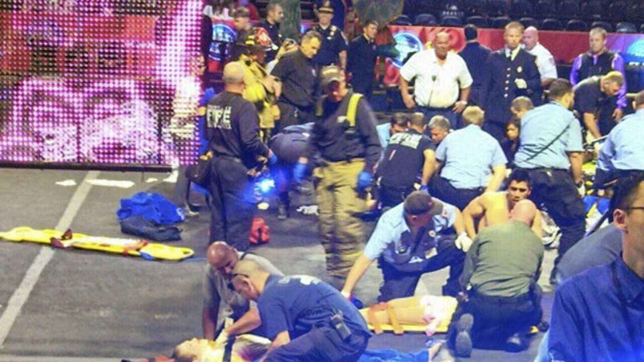 First responders work at the center ring after a platform collapsed