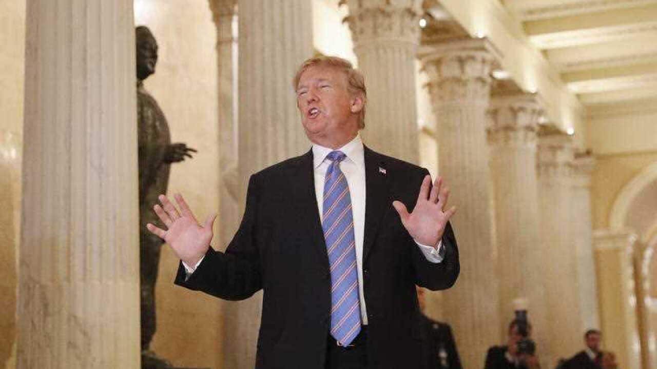 President Donald Trump speaks in the Hall of Columns as he arrives on Capitol Hill in Washington.