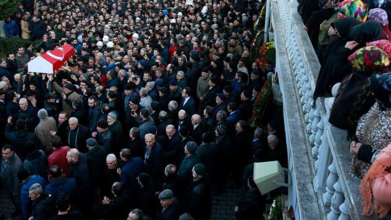 Mourners carry the Turkish flag-draped coffin of a nightclub attack victim during the funeral in Istanbul