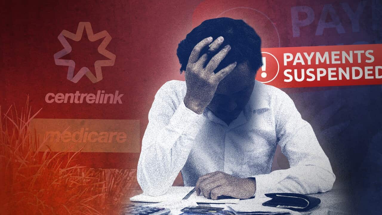 Composite image of a person at a desk with head in hands, and 'payment suspended' notification and Centrelink sign in background