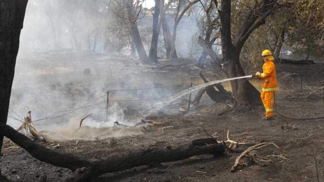 Firefighters work to contain a bushfire near Scotsburn, South of Ballarat in Victoria last week.