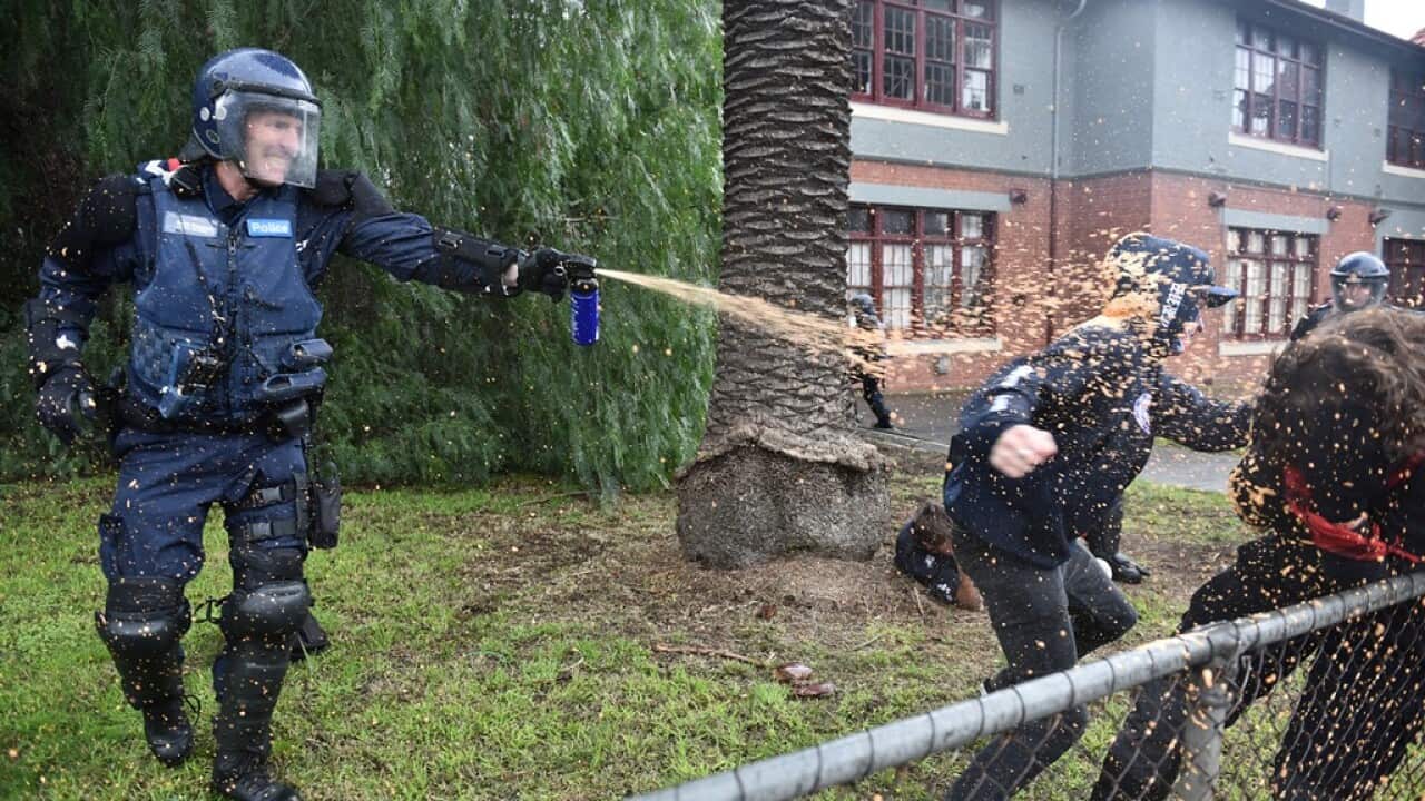 Police deploy capsicum spray as anti-immigration and anti-racism protesters clash in Coburg in Melbourne, Saturday, May 28, 2016. (AAP Image/Julian Smith) NO ARCHIVING