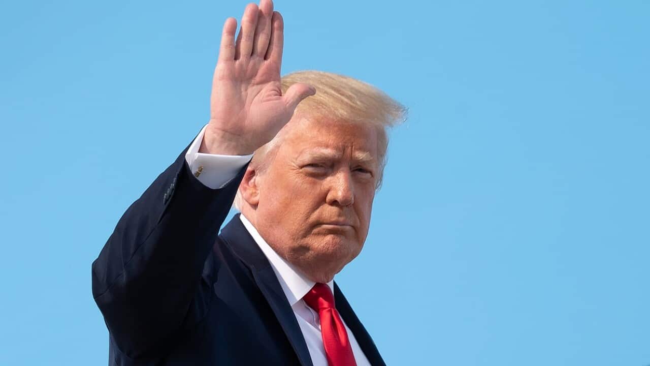 Donald Trump waves as he boards Air Force One on the weekend.