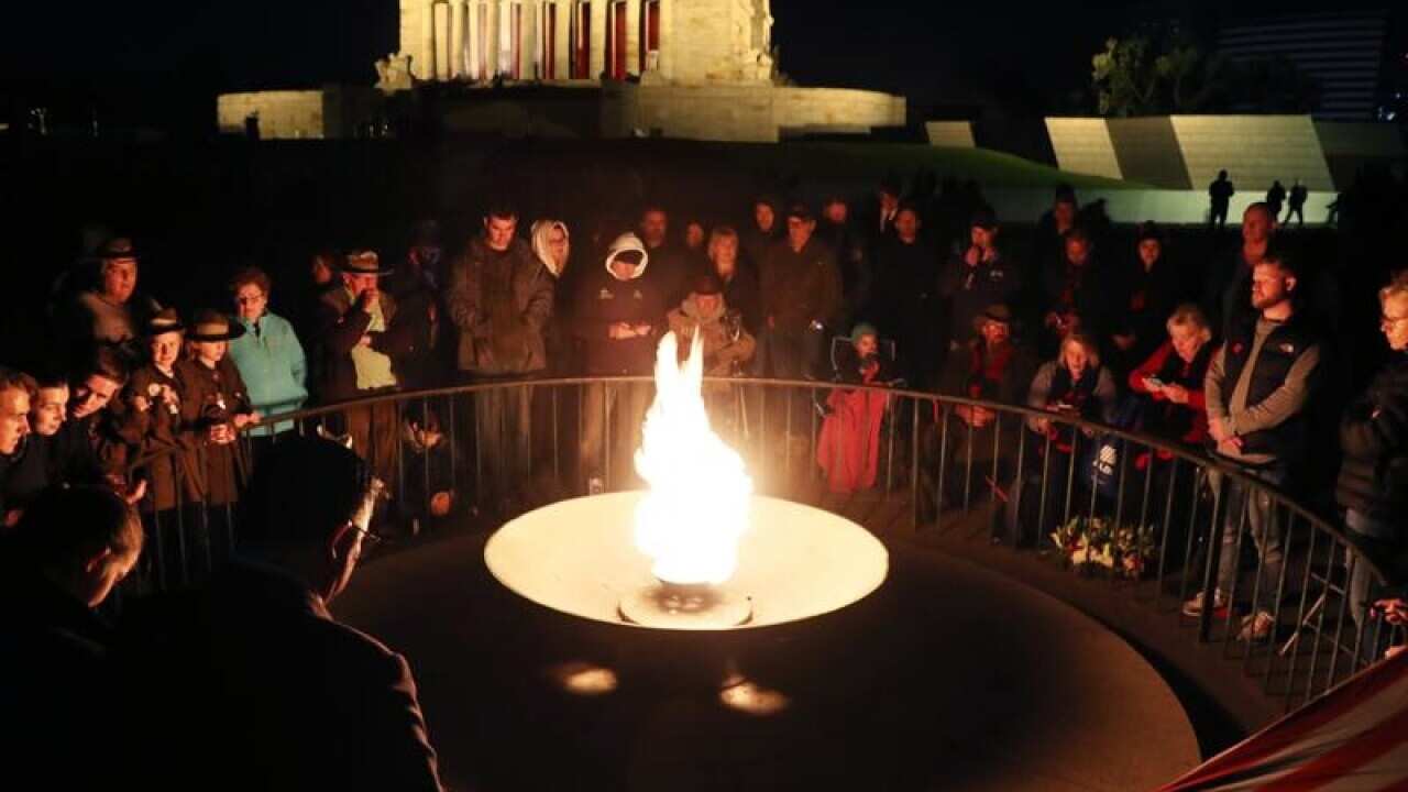 Crowds at the perpetual flame at Melbourne's Shrine of Remembrance.