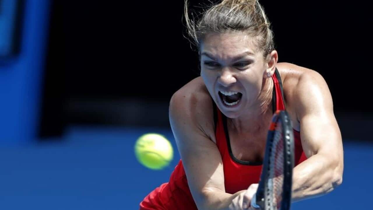 Romania's Simona Halep makes a backhand