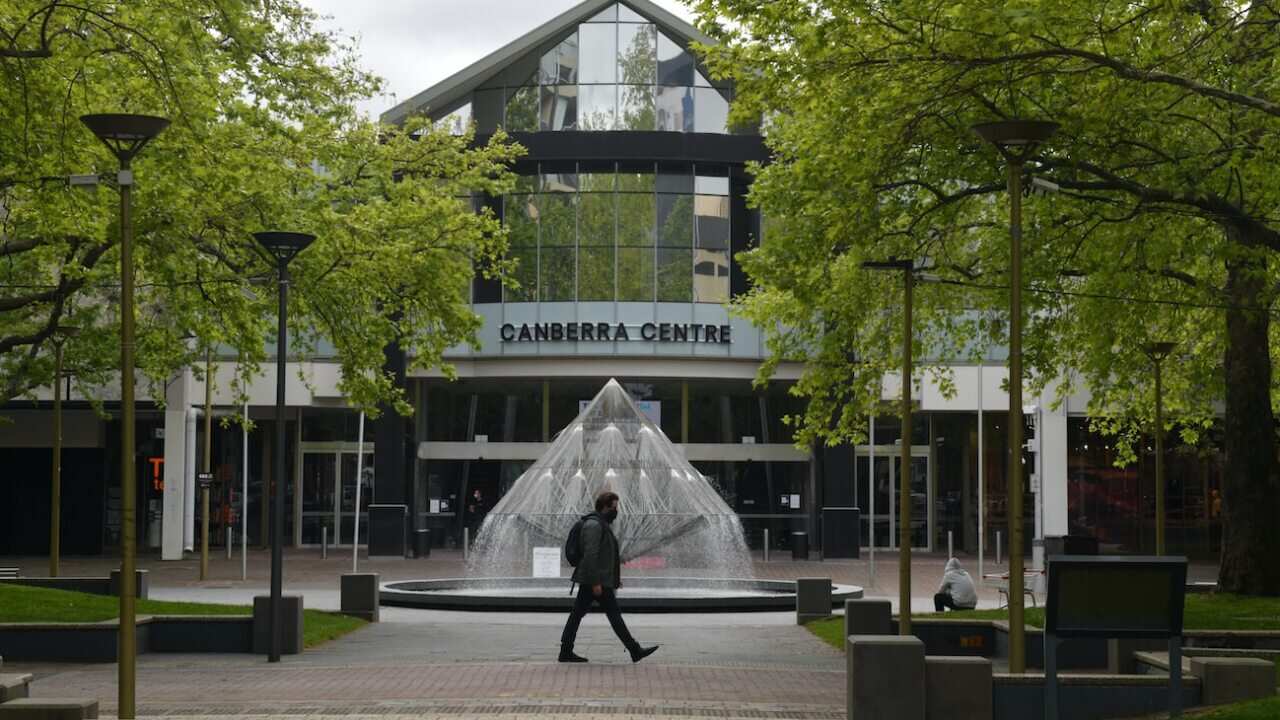A pedestrian walks past the Canberra Centre on Friday, October 15, 2021