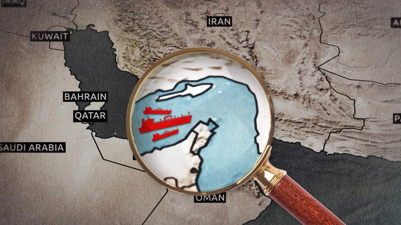 A magnifying glass hovers over a stylised map of the Middle East, highlighting red ship icons navigating the Strait of Hormuz between Iran and Oman.