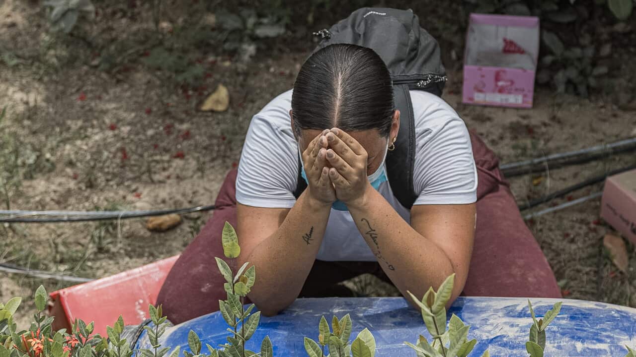 A woman prays in an area affected by the earthquakes in La Guaira, Venezuela, 28 June 2026.