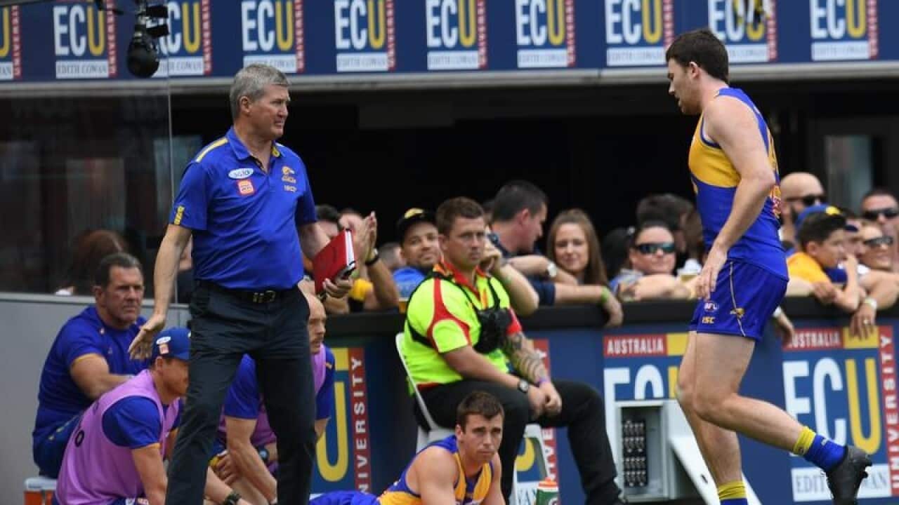 West Coast player Jeremy McGovern (R) leaves the field