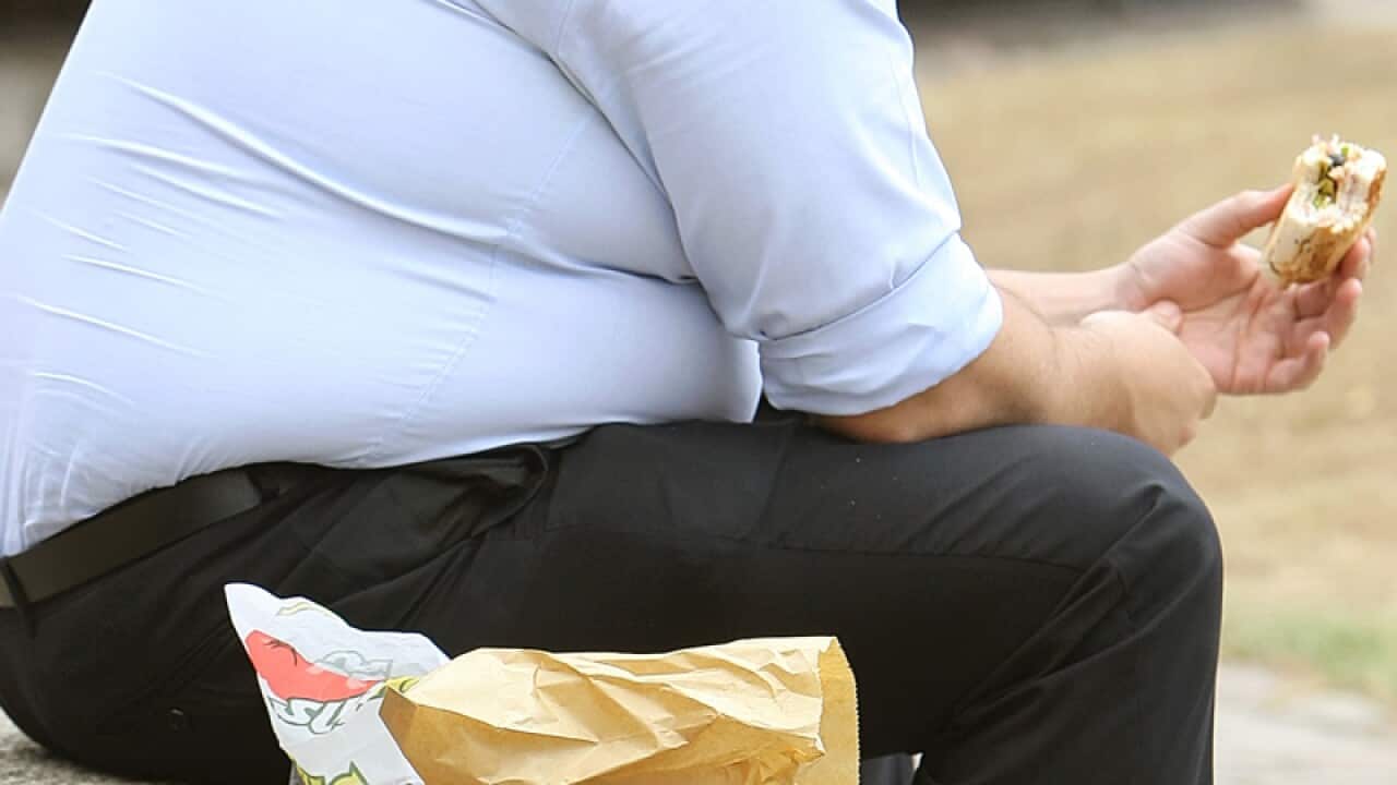 An overweight man eating