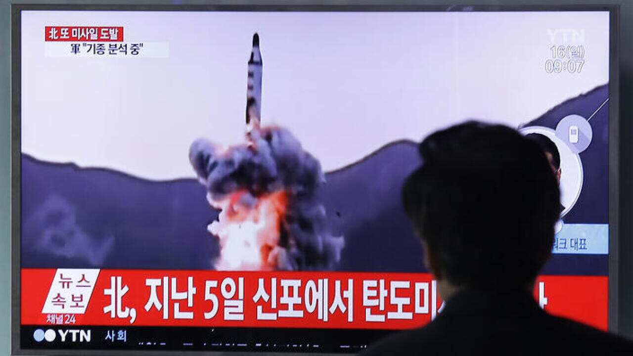 A visitor watches a TV showing file footage of a North Korea's ballistic missile at Seoul Railway Station in Seoul, South Korea.