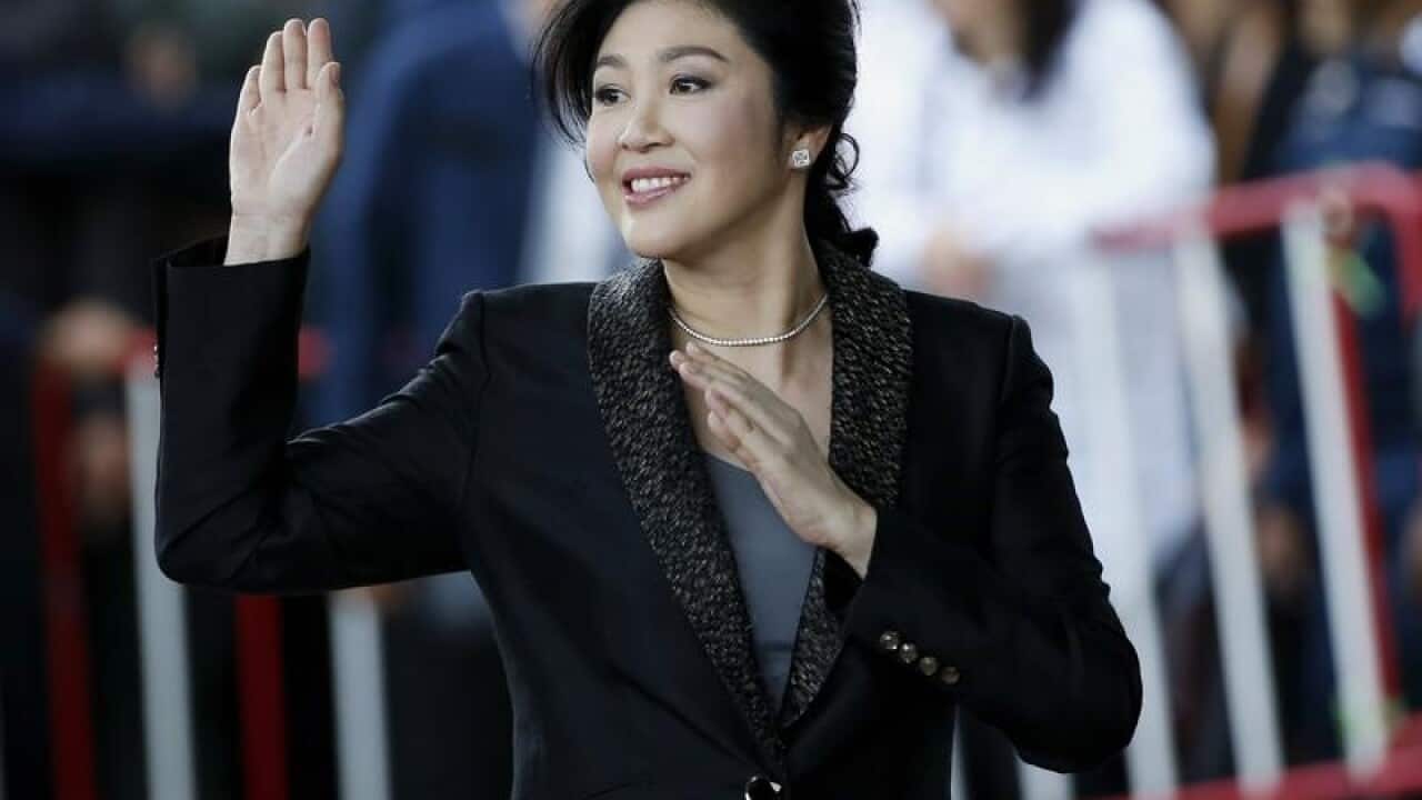 Former Thai prime minister Yingluck Shinawatra waves to supporters.