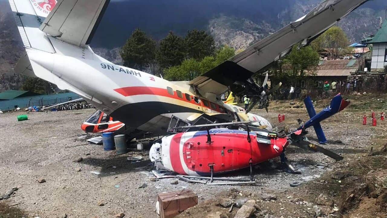 A Summit Air Let L-410 Turbolet aircraft is seen after it hit two helicopters during take off at Lukla airport in Nepal.