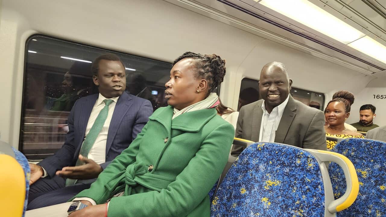 Hon, Awel Deng on Train.jpg