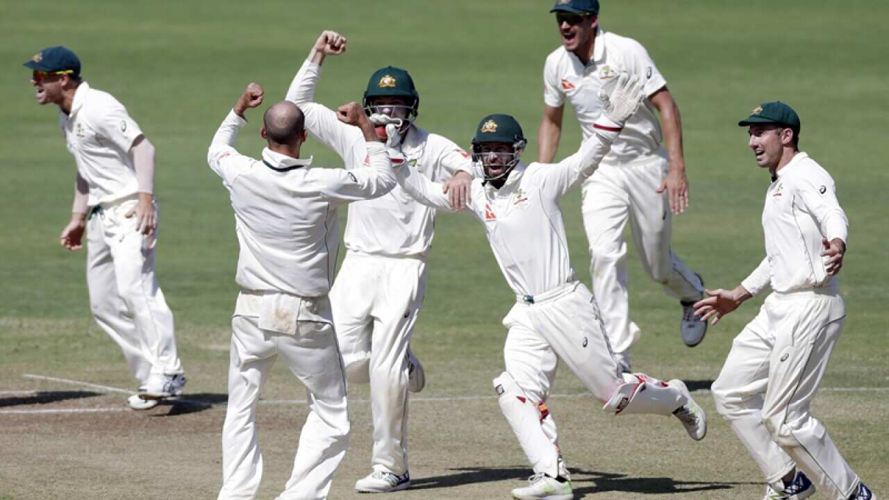 Australia players celebrate after winning the first test in Pune