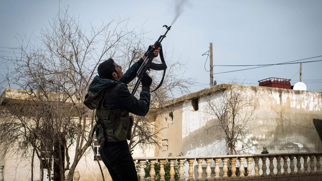 A rebel fighter in Syria fires at a government aircraft - Getty-1.jpg
