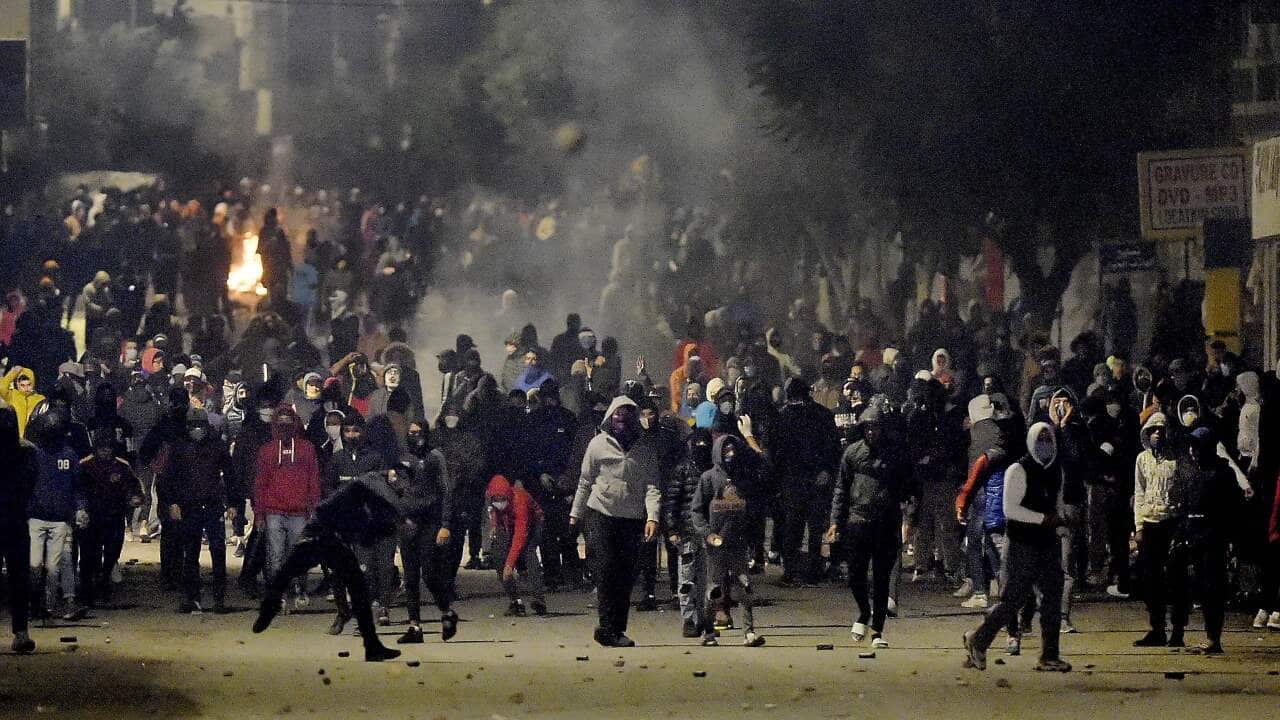 Tunisian protesters block a street during clashes with security forces in Ettadhamen on the northwestwern outskirts of Tunis on 18 January.