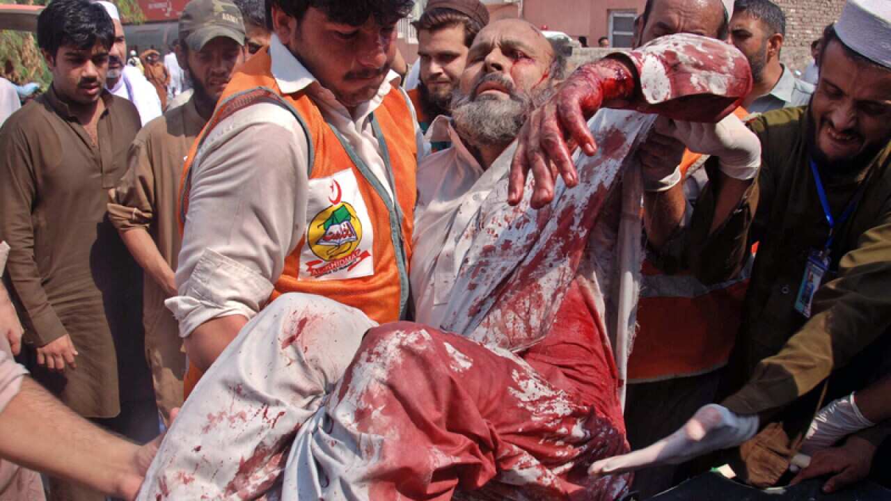 An injured bomb blast victim is taken care of by paramedics