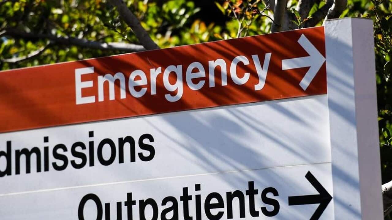 A hospital sign pointing to the emergency room.