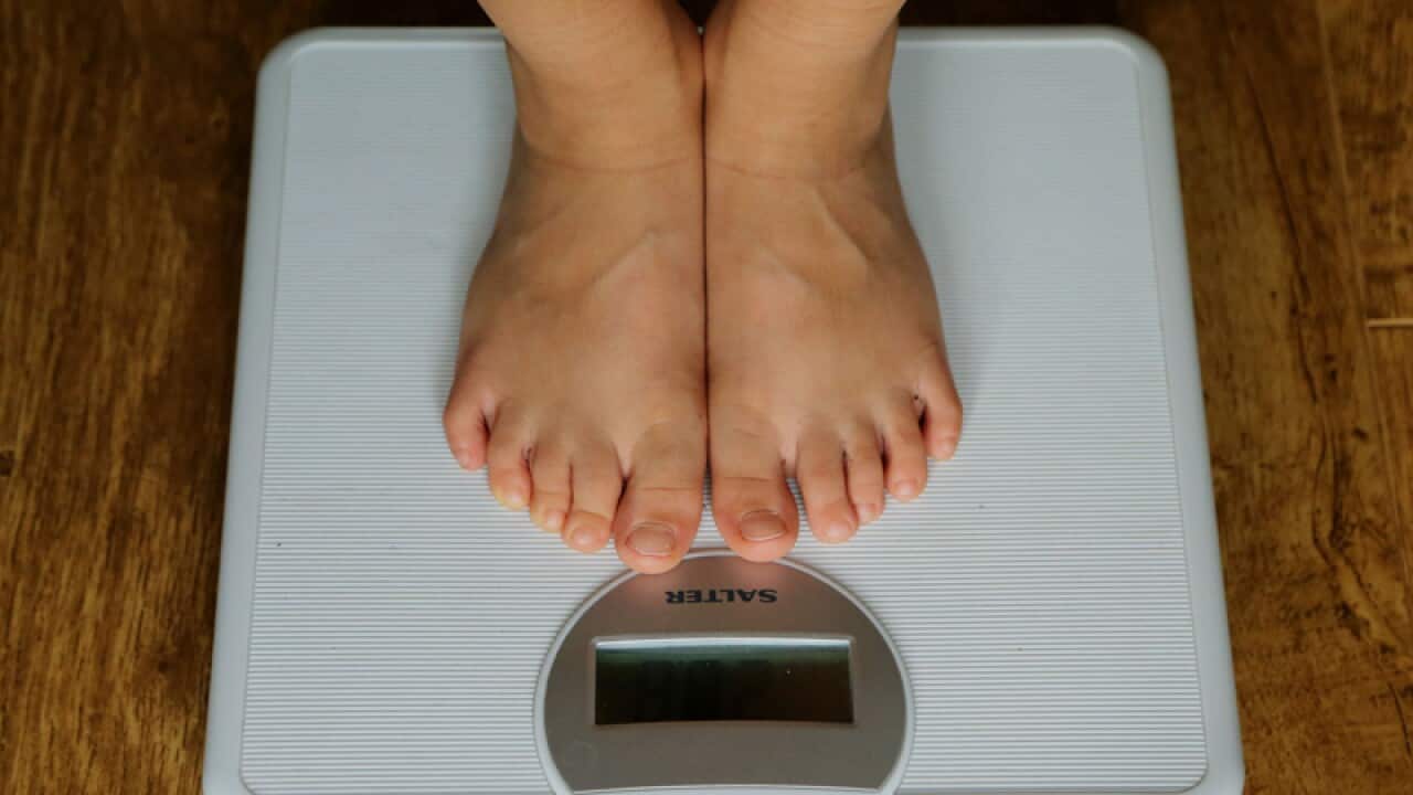 a young child being weighed on scales