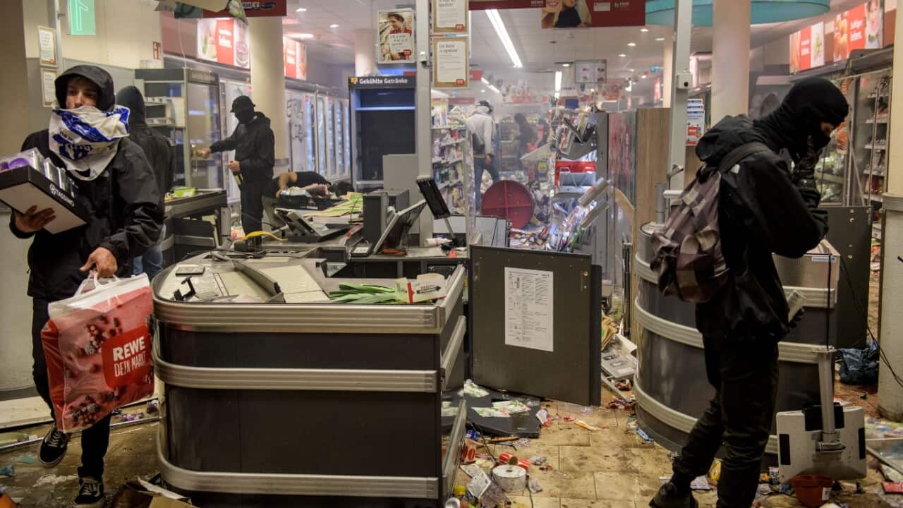 Protesters against the G20 Summit plunder and destroy a Rewe supermarket in the Schanzenviertel district on July 7, 2017 in Hamburg
