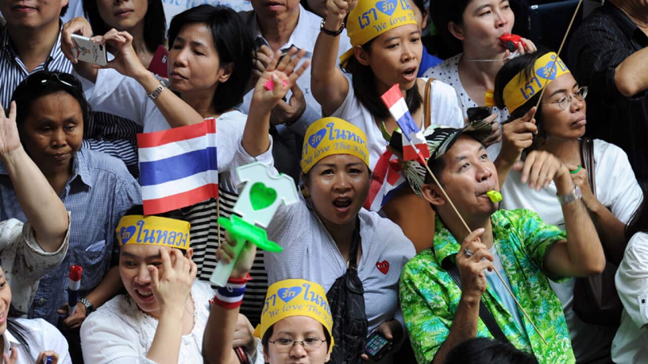 Thai opposition protesters shout slogans during a rally